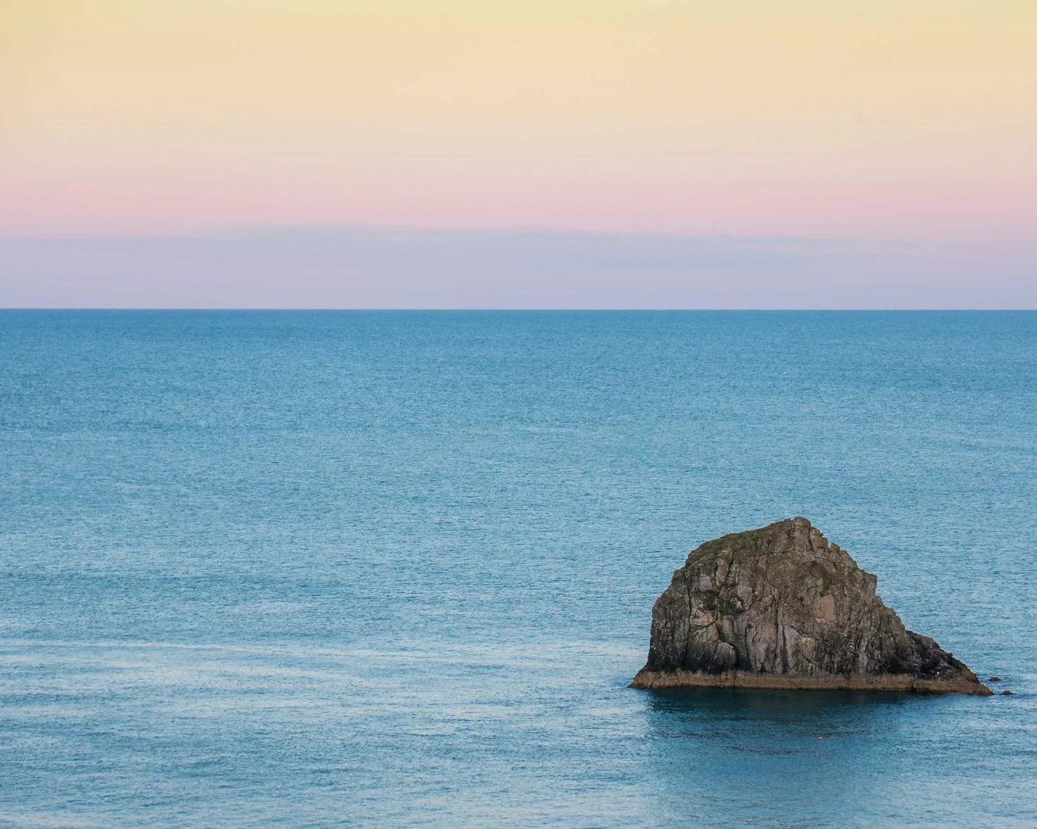 Open sea and a distant rock on the horizon